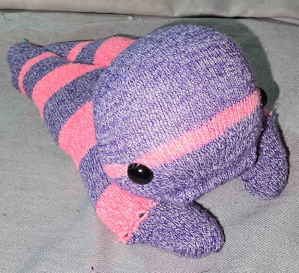A pink and purple creature with a complexing expression.